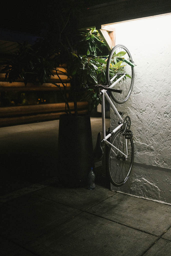 A fixed-gear bike under some bright lights