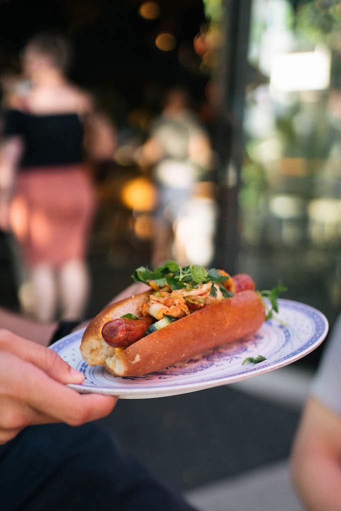 A kimchi hotdog on a plate