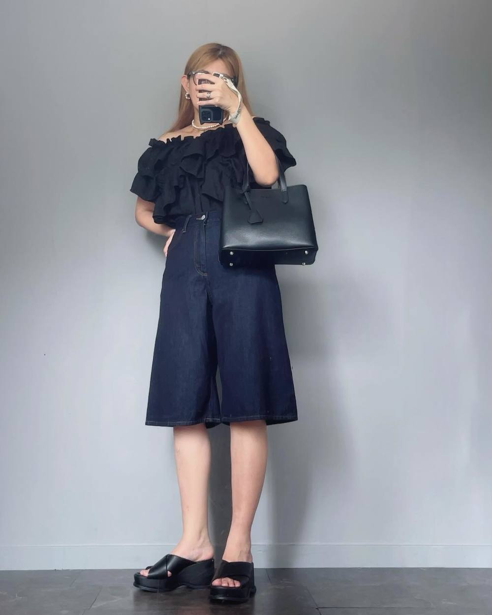 ひざ丈プリーツスカート、ネイビーセーター 控え目ながら華やかな女性