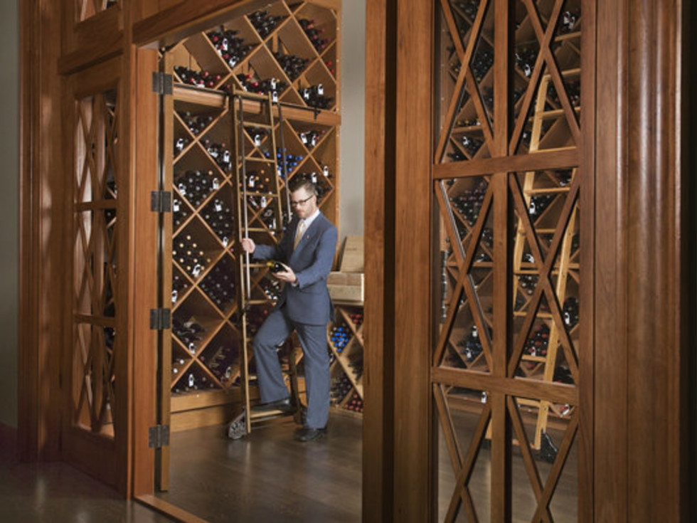 Man picking out bottles from a wine cellar