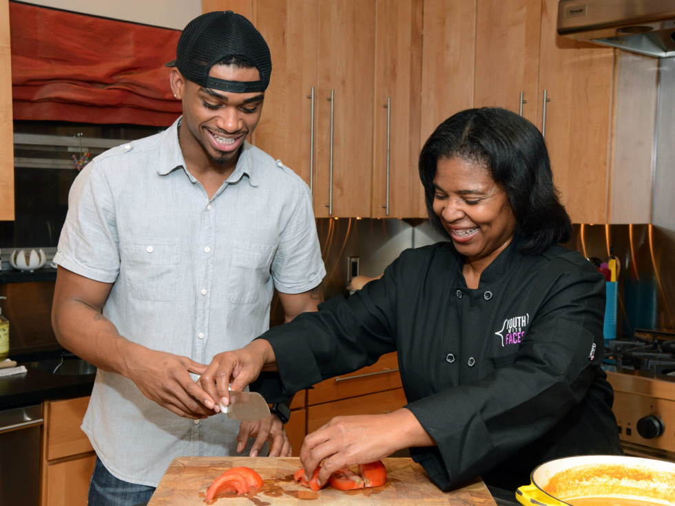 Youth With Faces graduate and Culinary Arts program director Terry Lynn Crenshaw cook together after his release