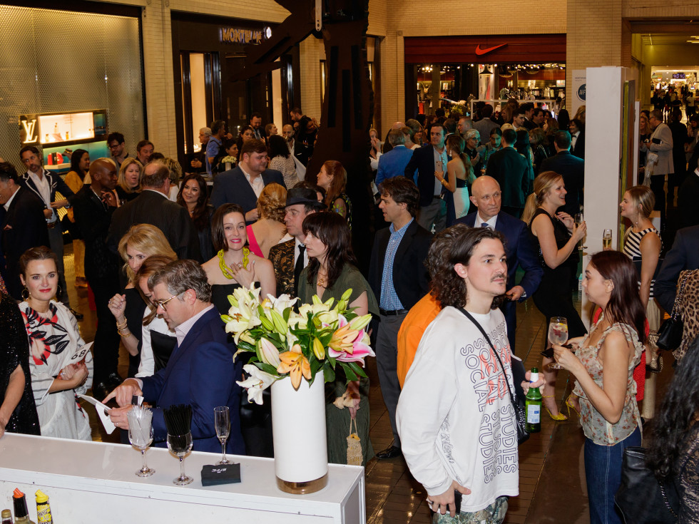 The crowd milled among luxury shops during the cocktail hour