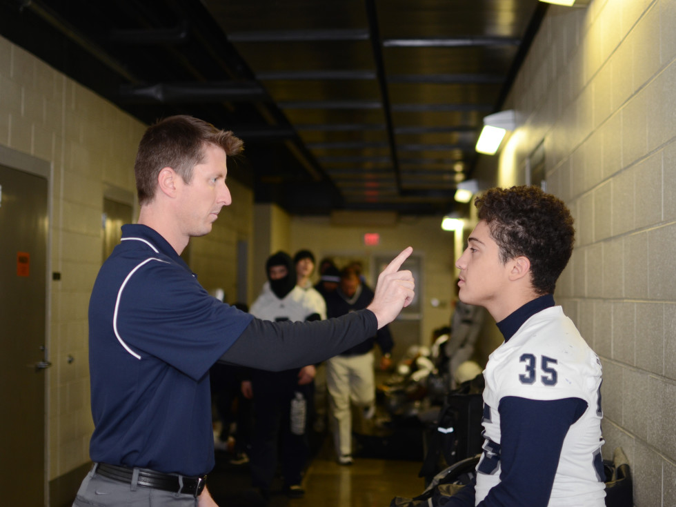 Doctor examining a young football player