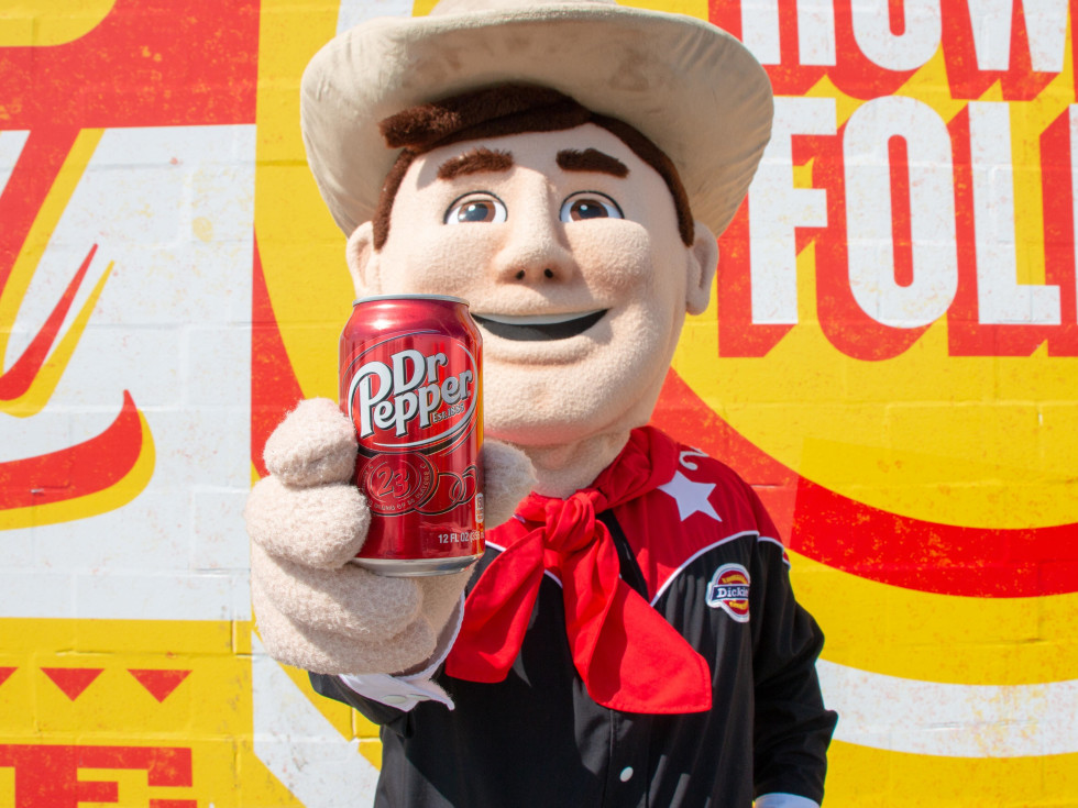Big Tex holding a Dr Pepper can