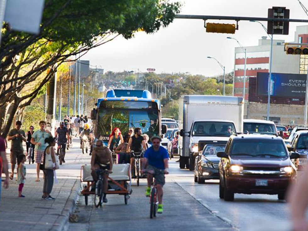 Cap metro bus cyclist busy downtown Austin street