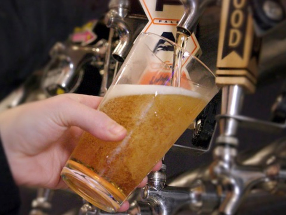 Bartender filling a beer glass