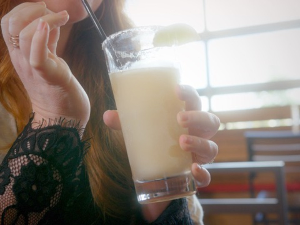 Woman drinking a margarita