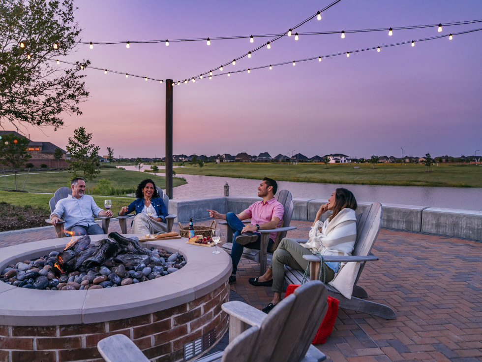 People around a fire pit at sunset