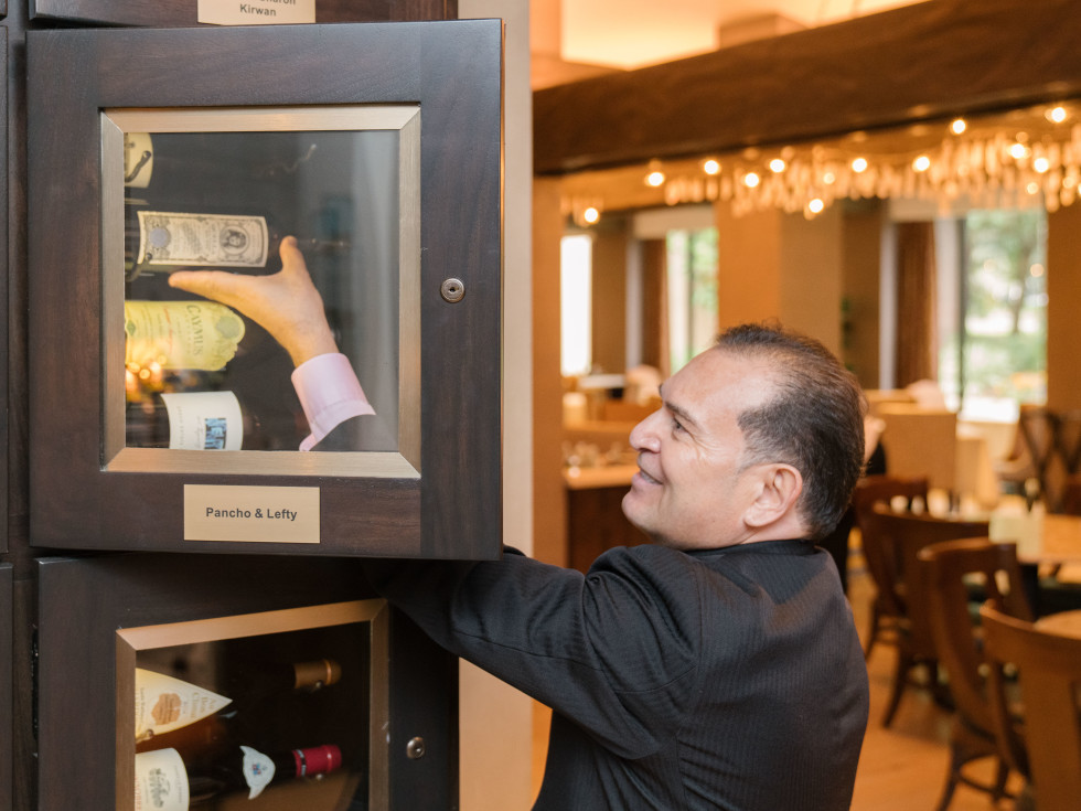 TRIBUTE’s wine story begins with rows of back-lit wine lockers tended by maître d' Frank Perez