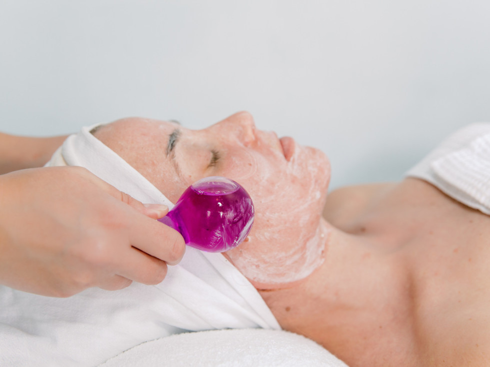 Woman receiving a facial at Bare Necessities Spa