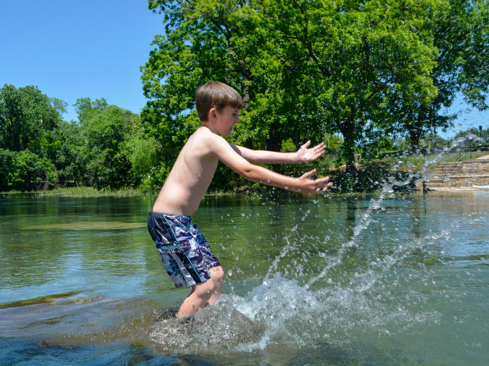 Boy splashing in the San Marcos River