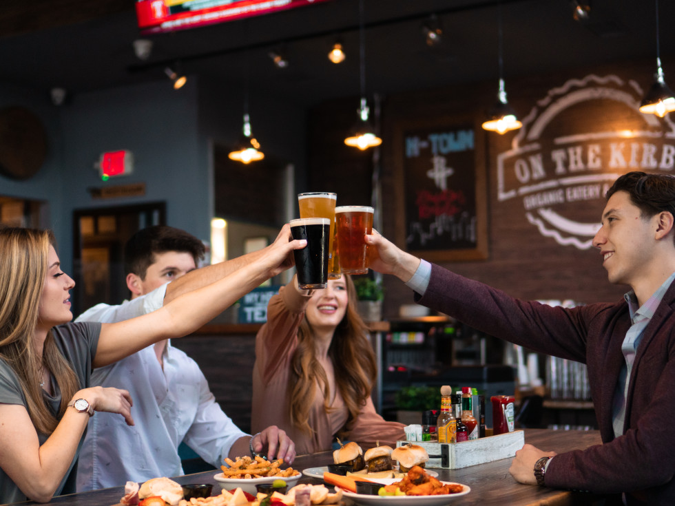 People toasting in a bar