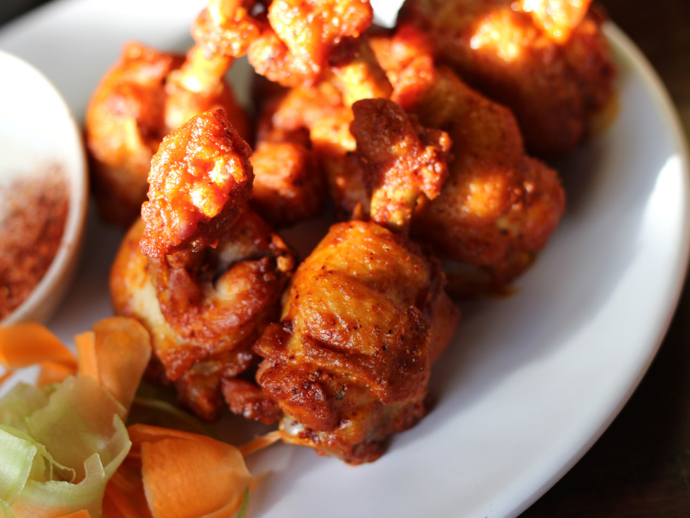 Crispy buffalo wings with a carrot and celery slaw.