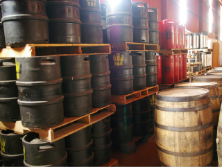 Hops and Grain brewing storage with barrels and kegs