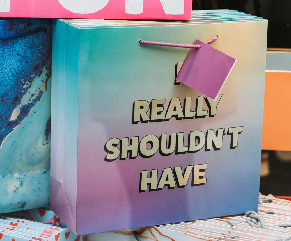 Paper shopping bags printed with statement 'I really shouldn't have'