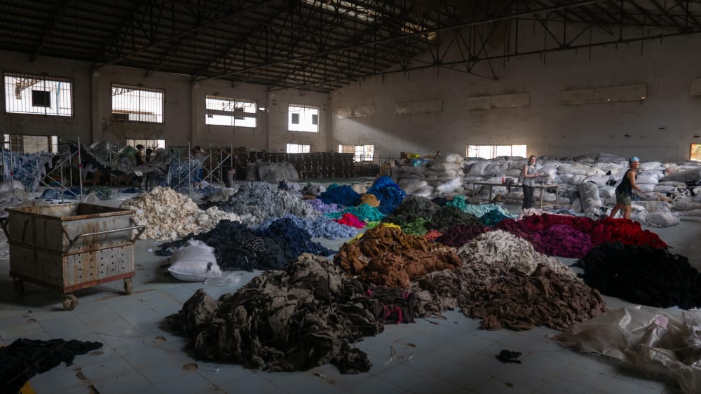 Sorting through hundreds of tons of clothing in an abandoned factory for a social mission called Clothing the Loop<strong>.</strong>