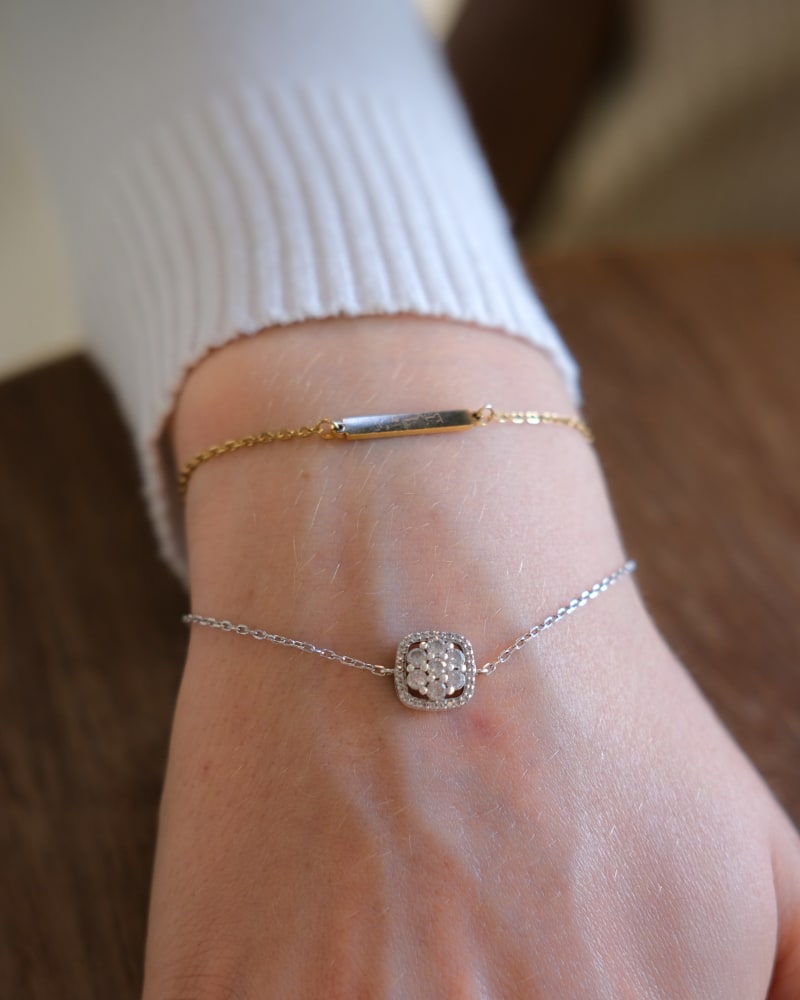 Person wearing a gold and silver bracelet