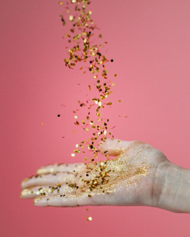 Hand of person catching glitters