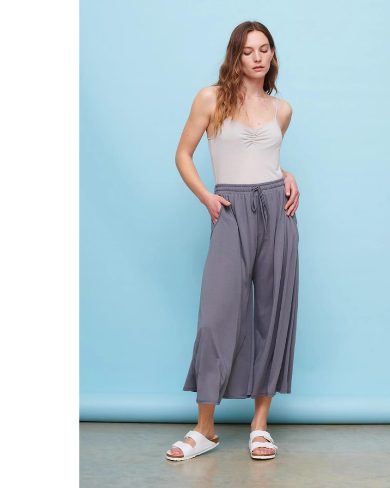 Female model wearing a pair of light grey comfy culottes