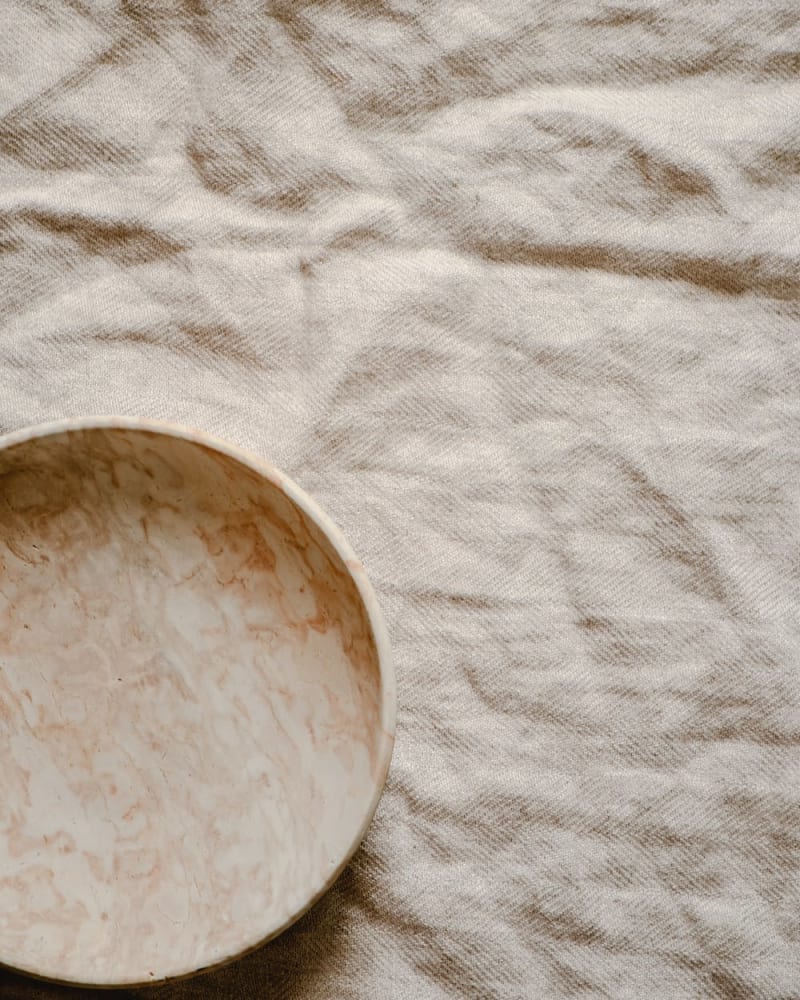 A marble bowl on linen fabric