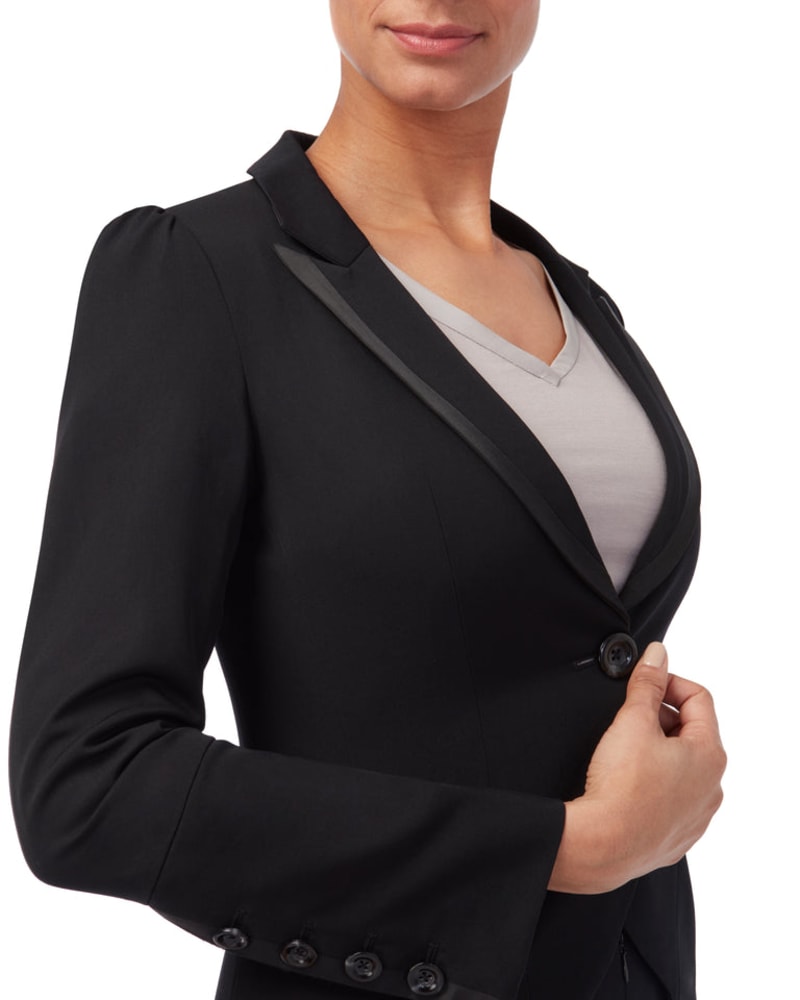 Close up of a woman wearing a tailored black tuxedo jacket