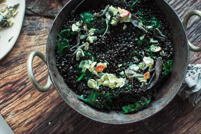 A bowl of beluga lentils with garlic and sage.