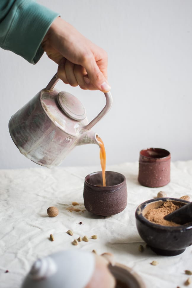 Pouring of chai masala in the cups.