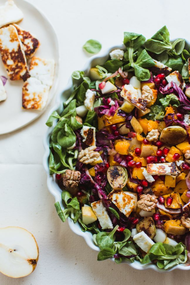 Autumn abundance salad filled with rapunzel, pomegranate, Brussels sprouts, pumpkin, goats cheese, walnuts ...