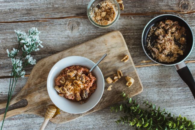 Millet porridge topped with figs, walnuts, coconut and honey