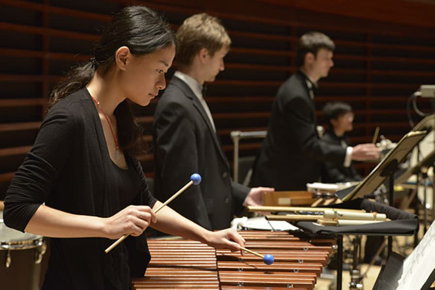 Curtis percussion students concentrate during an orchestra performance.