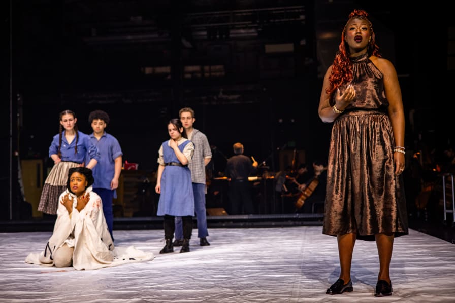 Nikan Ingabire Kanate (Narrator), front; with Jeysla Rosario Santos (Reader), kneeling; and Carlyle Quinn, Henry Drangel, Maya Mor-Mitrani, and Sebastian Wittmoser Herrera (L–R).