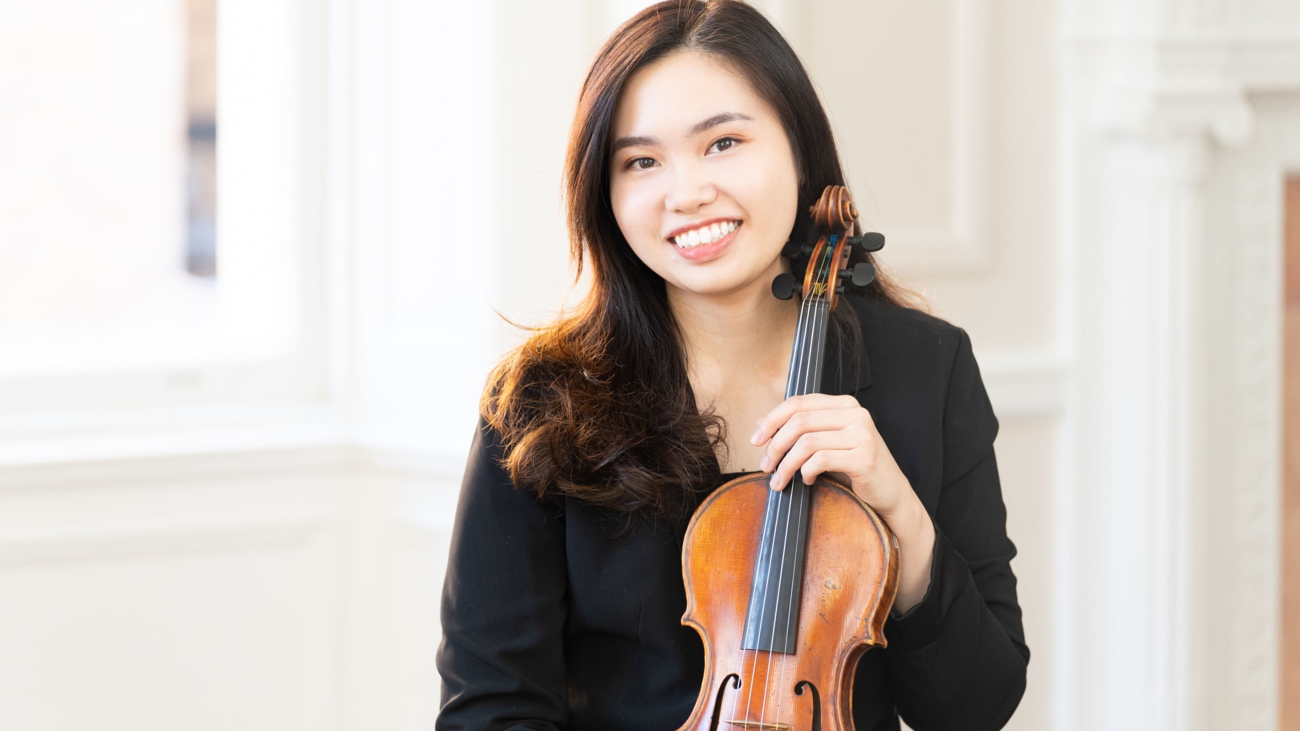 Portrait of Cherry Yeung holding a violin