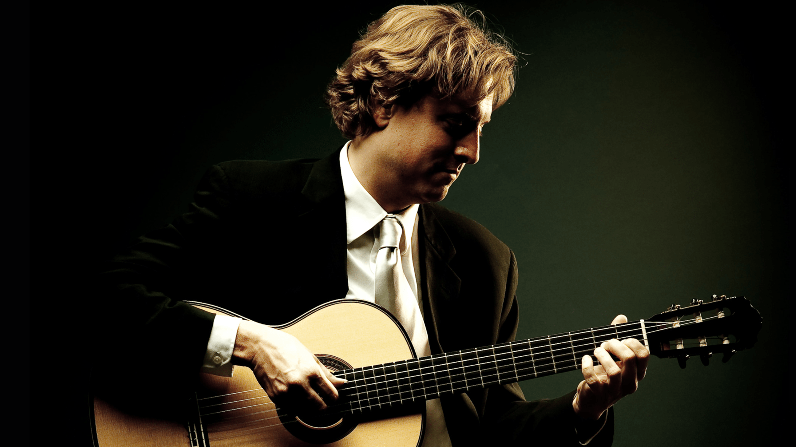 Portrait of Jason Vieaux playing guitar