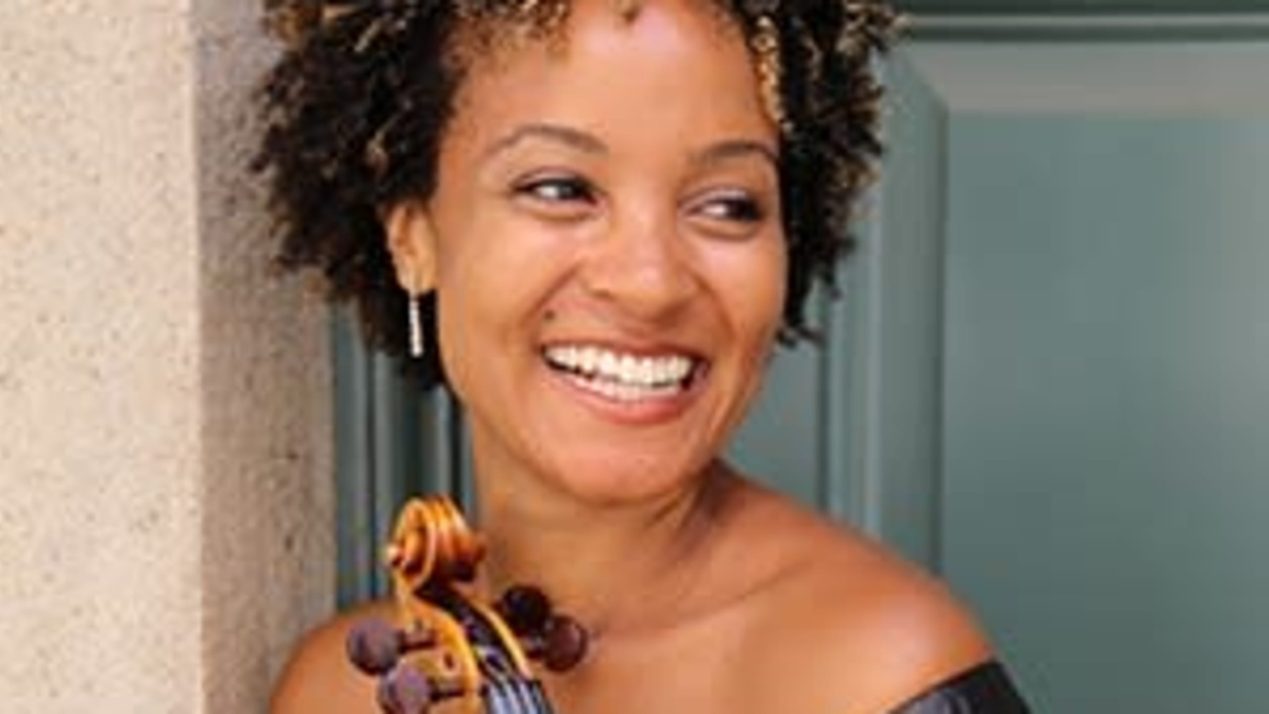 Melissa White holding a violin.