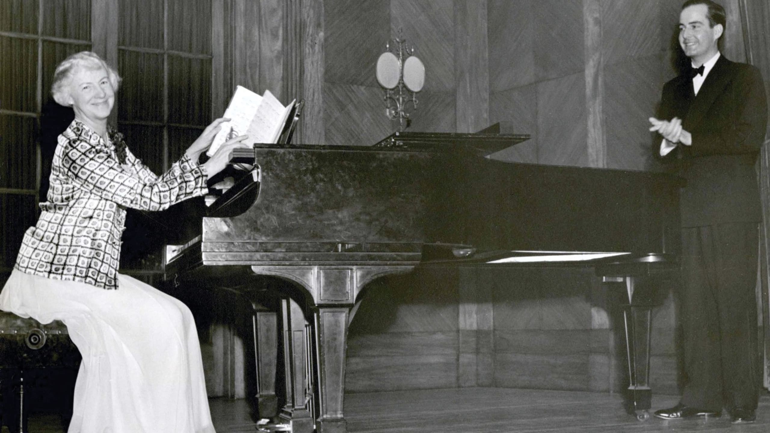 Samuel Barber and Mary Louise Curtis Bok on stage with a piano
