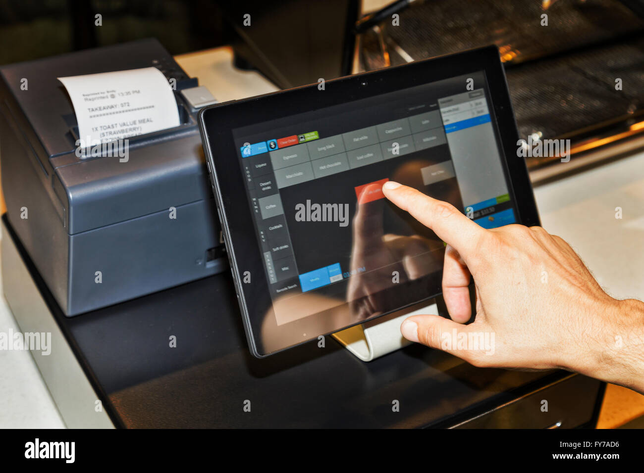 Cafe waiter using a POS terminal