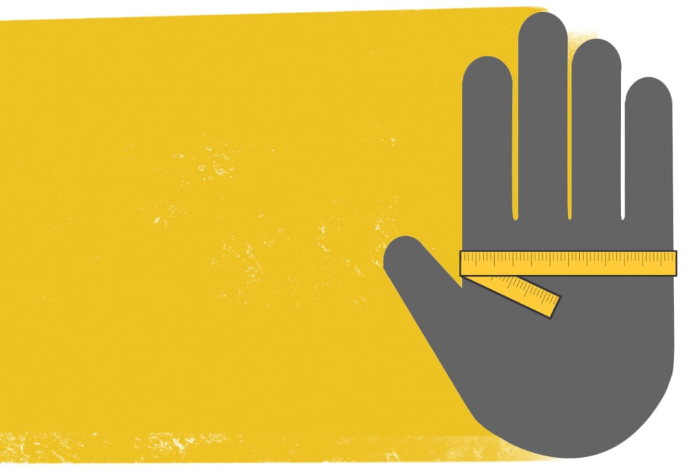 Hand with a tape measure wrapped around it just below the knuckles