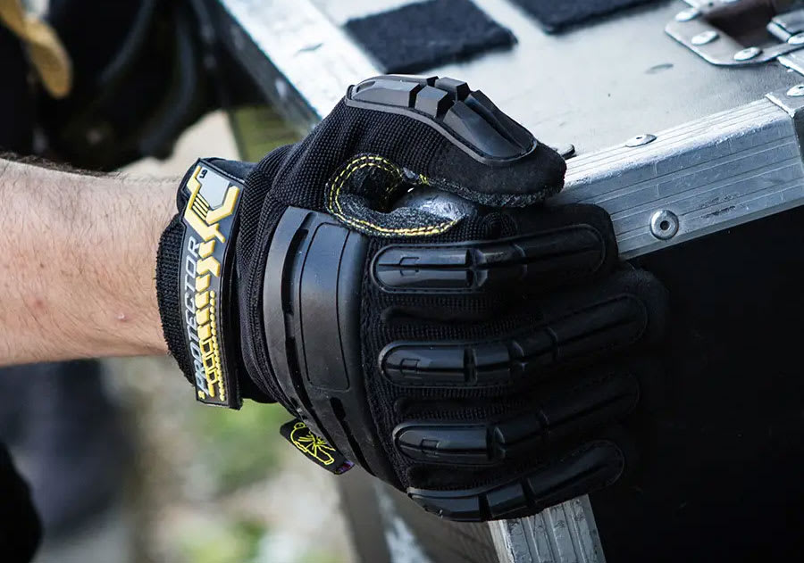 Dirty Rigger work glove gripping a flight case