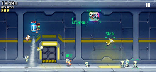 Jetpack Joyride 1.104.2 – the lab corridor: Barry on the Machine Gun Jetpack, a Lil' Stomper vehicle token floating ahead, scientists running along the floor, 1,949 m and 262 coins at the top