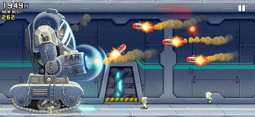 Jetpack Joyride 1.104.2 – Barry inside the S.A.M. Strong Arm Machine swatting three incoming orange missiles with smoke trails in the lab, 1,949 m on the distance counter