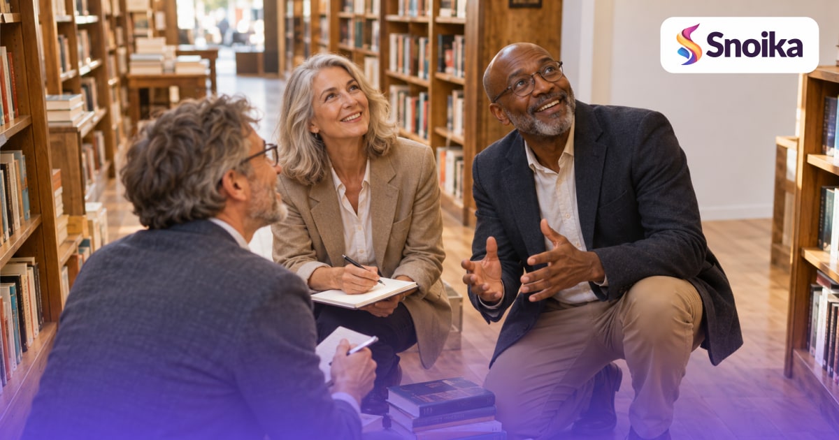 Three people in their fifties and sixties in an independent bookstore between tall shelves.