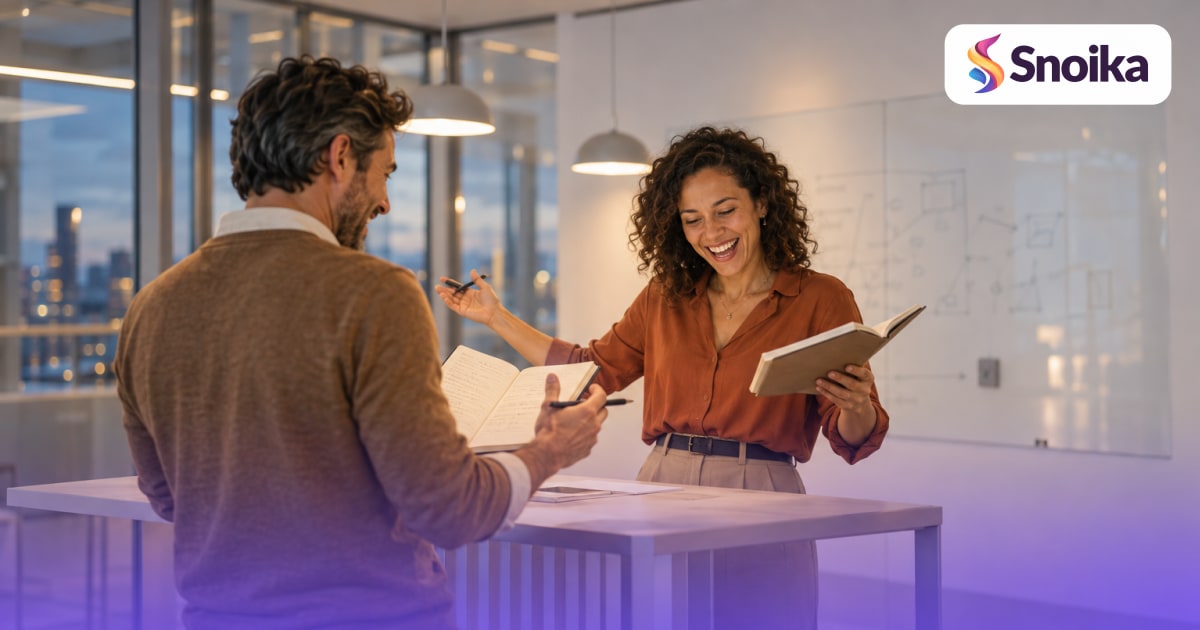 Two people in their forties in a glass-walled meeting room with a whiteboard.
