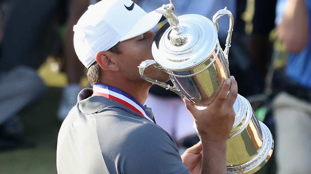 Brooks Koepka lifts the U.S. Open Championship trophy after winning the 2018 U.S. Open at Shinnecock Hills