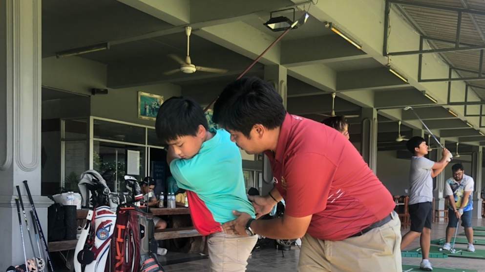 A golf lesson takes place at a school built by Thongchai Jaidee 