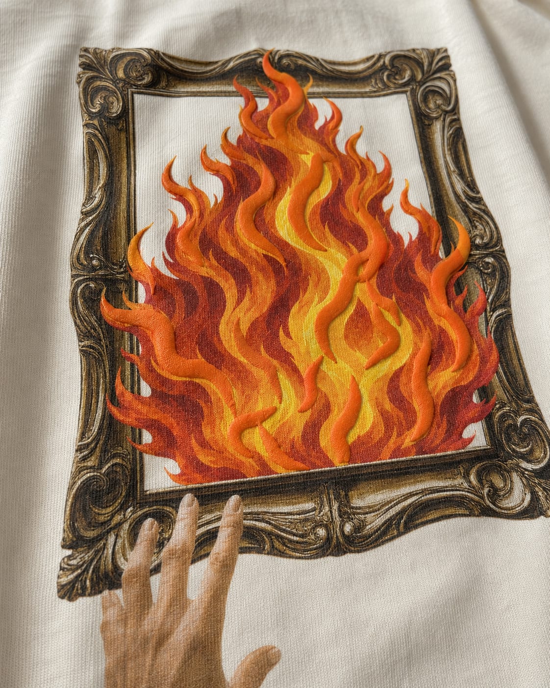 Close-up of the raised textured print on the white Fire T-shirt