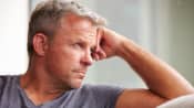 Man on couch looking out of the window