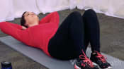 Woman lying supine doing abdominal curl ups.