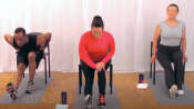 Three people doing a seated hamstring stretch.