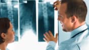 Doctor examining an X-ray of a patient&#039;s spine.