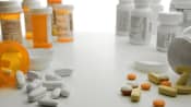Bottles of prescription medicines and bottles of over the counter medicines.